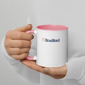 A person holding a pink and white coffee mug.