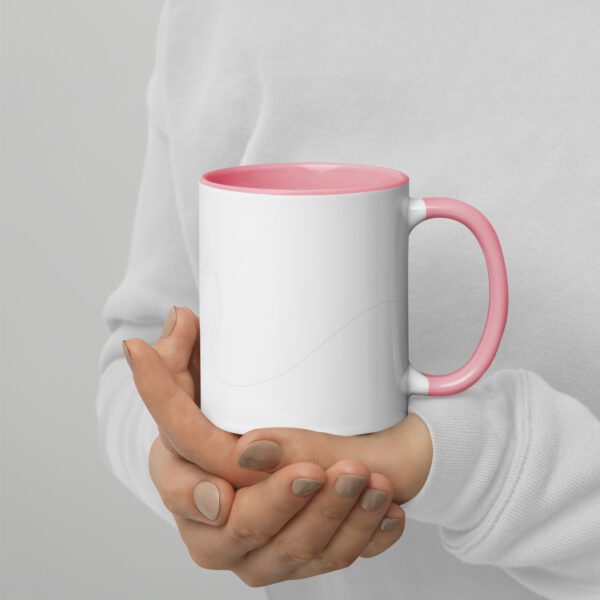 A person holding a pink and white coffee mug.