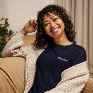 A woman sitting on the couch smiling for the camera.